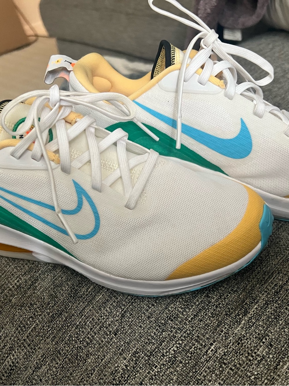 Nike White Sneakers with Blue, Green & Yellow Accents